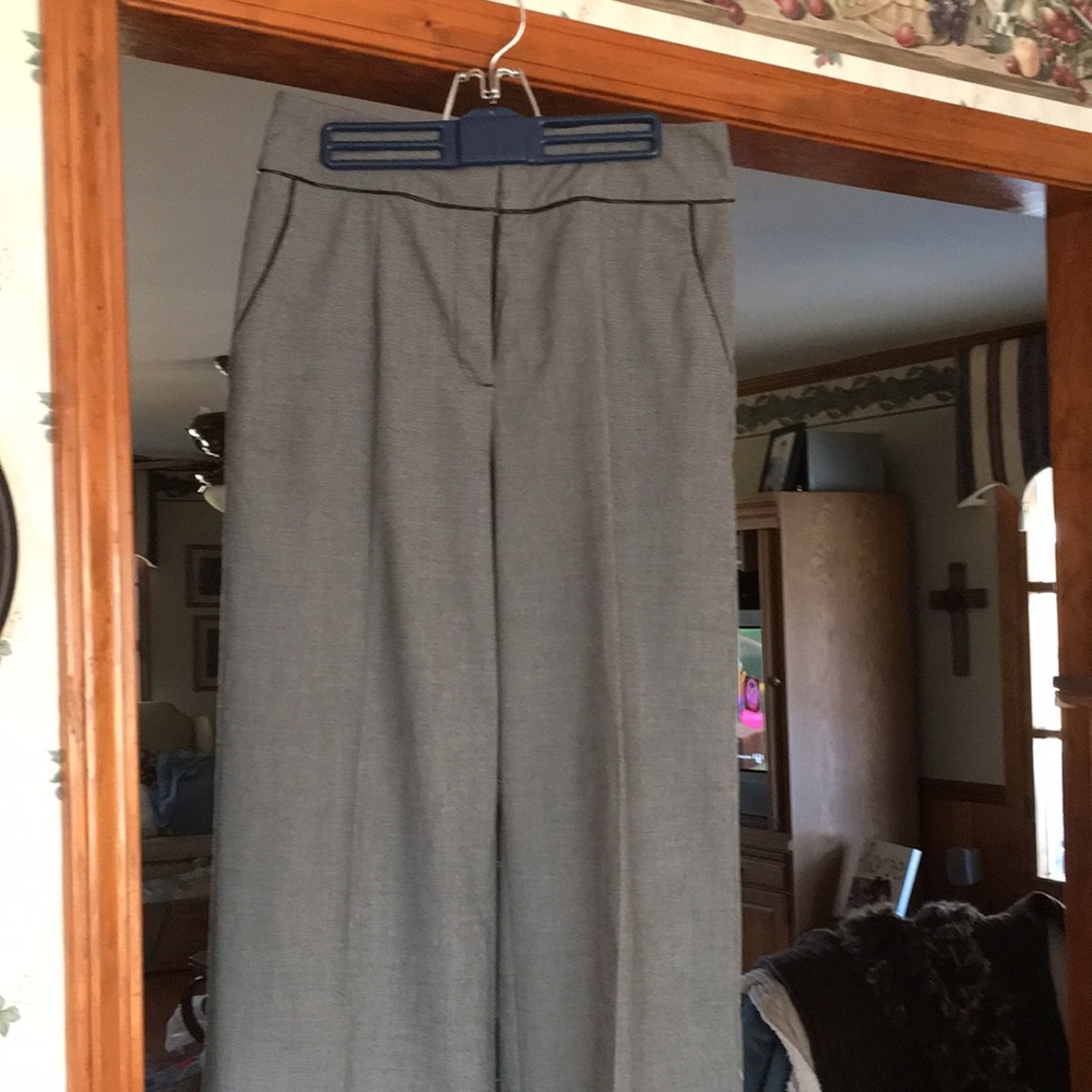 Wide leg trousers w/ fake leather trim around waist and down pockets.